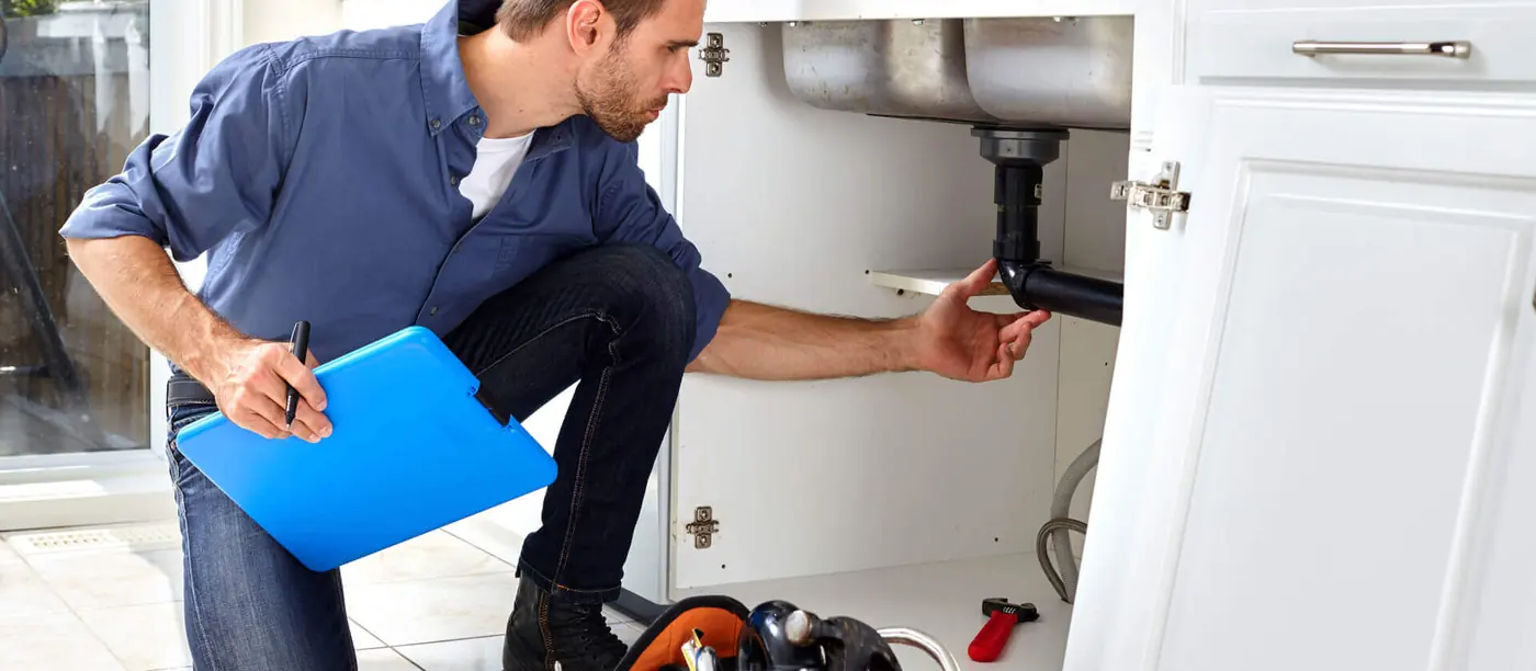 Installateur bei Arbeiten an einer Sanitärinstallation